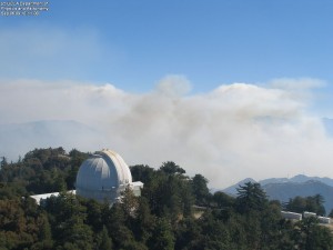 A recent view of the observatory showing one of the domes intact. The smoke from the fire is still visible in the background.
