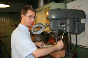 Guy Perrin building a support  at the machine shop for FIRST@LICK