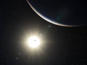 This artist’s impression shows the remarkable planetary system around the Sun-like star HD 10180. The large crescent is the third world in the system (HD 10180d), which is comparable to the planet Neptune in mass. The two inner planets appear as silhouettes in transit across the bright disc of the star. The outer planets in the system appear in the background sky.(Credit ESO)