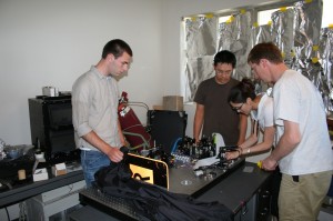 The team is preparing the table before the "operation" removing the fragile optics